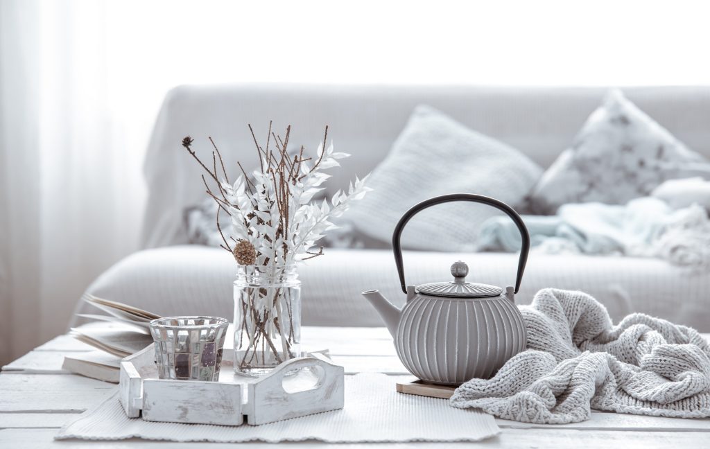 Home arrangement with teapot and Scandinavian decor details.