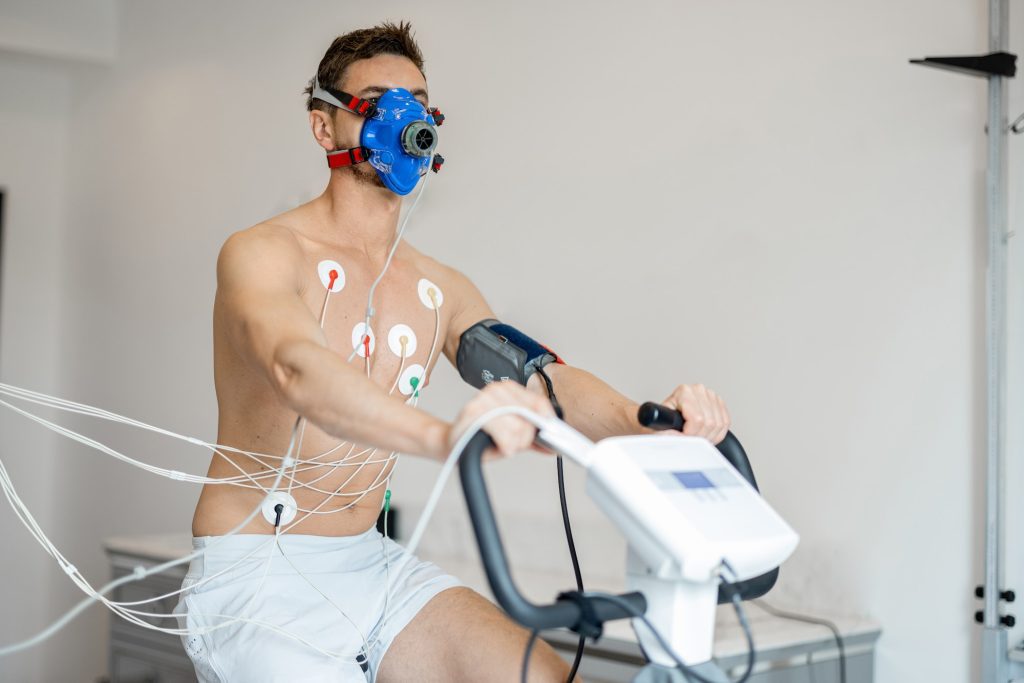 Man examining his cardiovascular system on bike simulator