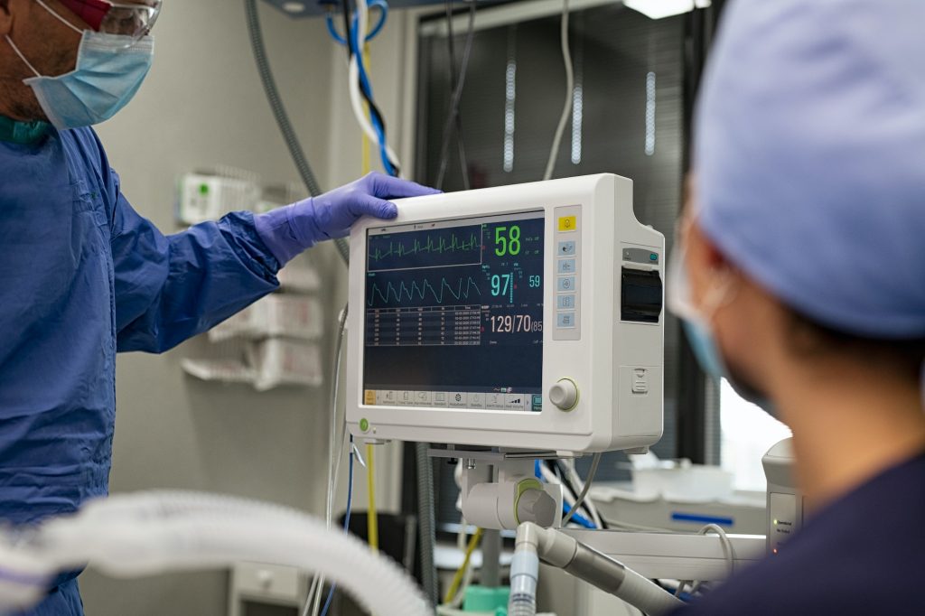 Surgeon checking heartbeat on monitor
