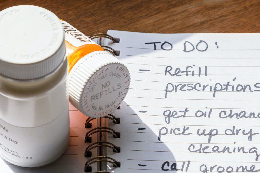 Hand written to do list with reminder to refill prescriptions