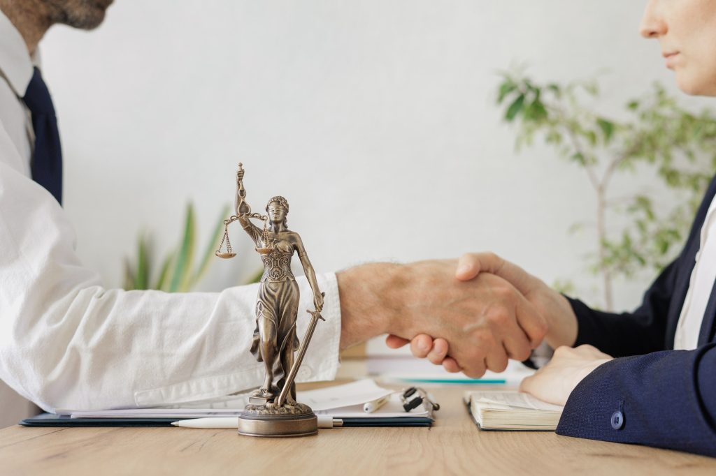 handshake of two diplomats during negotiations or the conclusion of a contract. legal advice