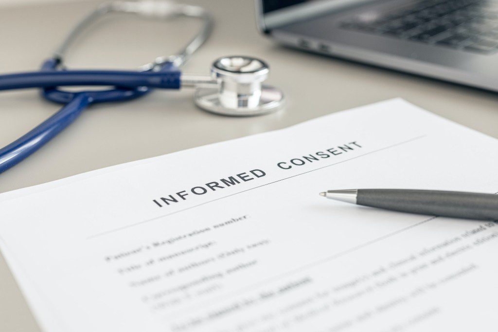 Informed Consent form on doctor desk