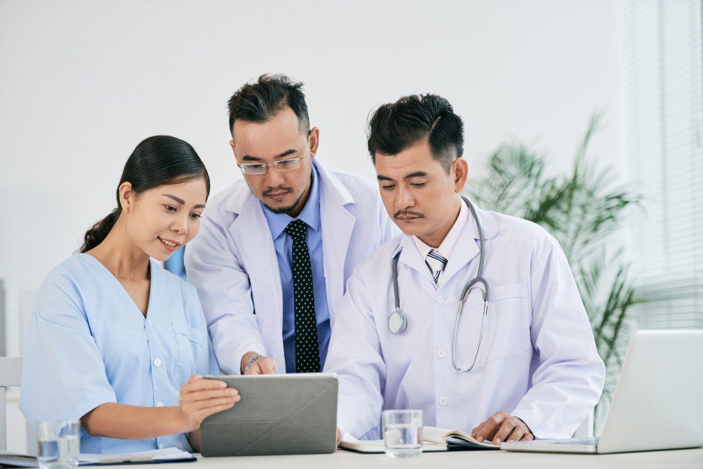 Nurse and doctors checking data