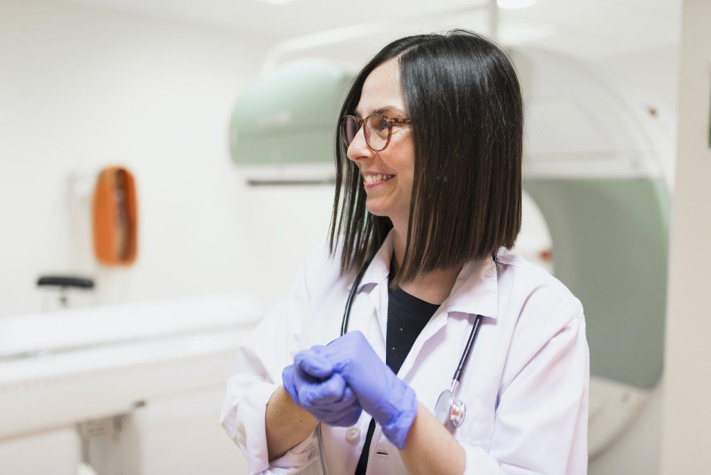 Smiling doctor wearing protective gloves