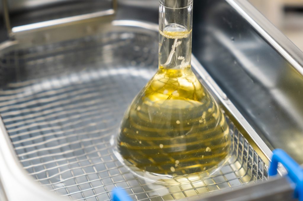 Yellow solution in the flask for dissolving or extraction into ultrasonic bath. Urea analysis