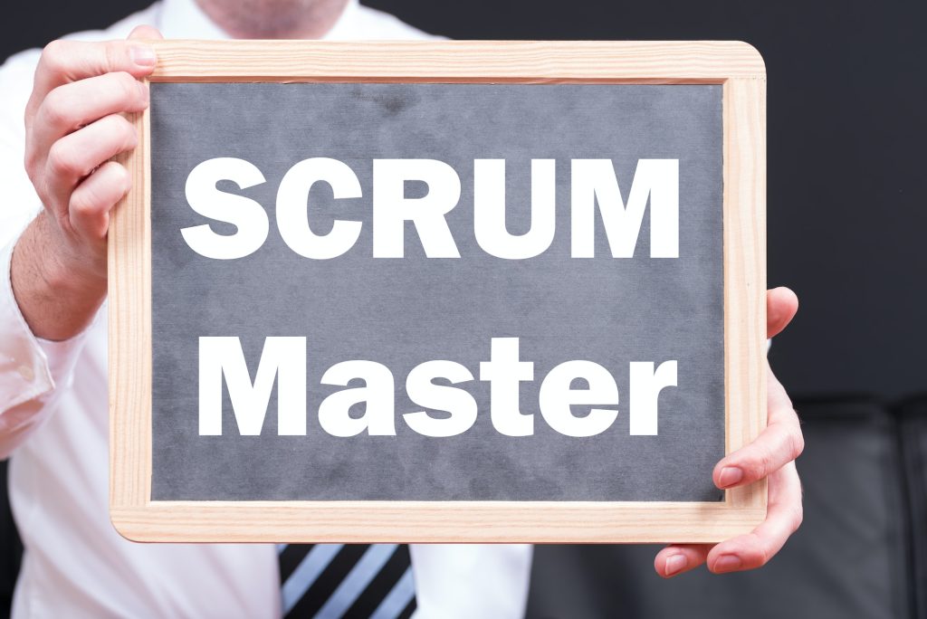 Businessman wearing a suit and holding a blackboard with the phrase SCRUM and SPRINT written on it