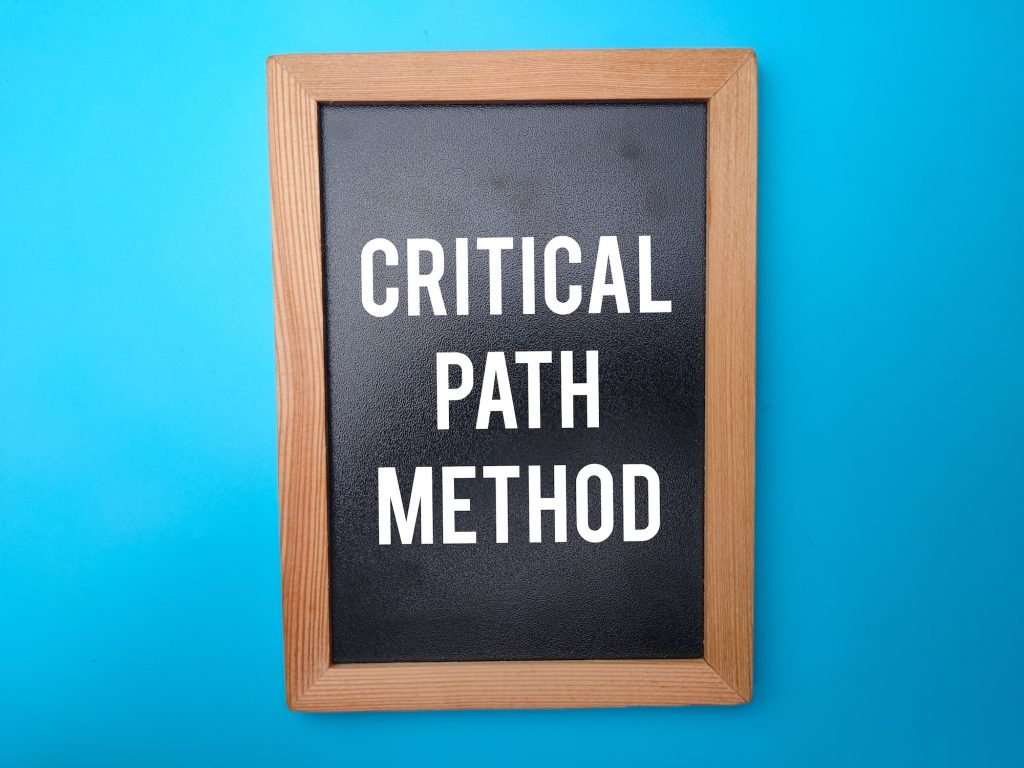 Wooden black board with the word CRITICAL PATH METHOD.