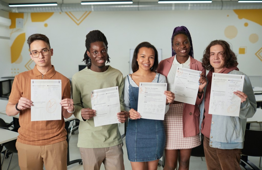 A group of people holding certificates