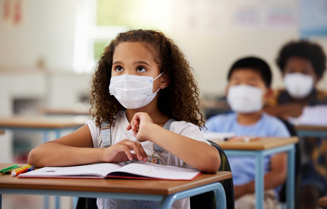 School student with covid learning in class, wearing mask to protect from virus and looking concent