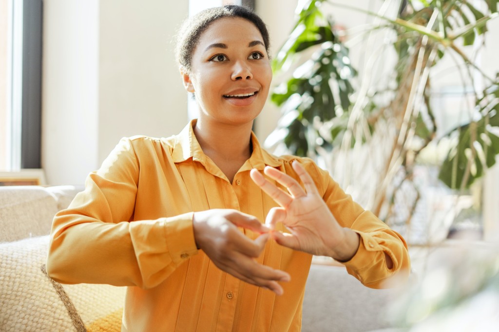 African American deaf sign language teacher communicating by hands gestures