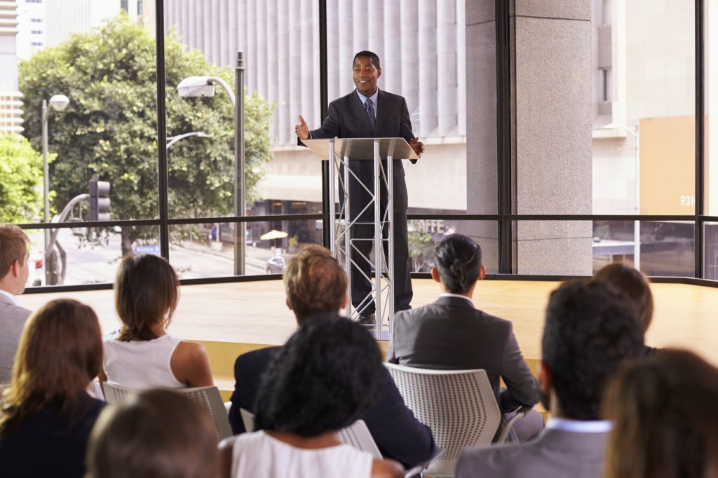 Black businessman presenting business seminar to an audience