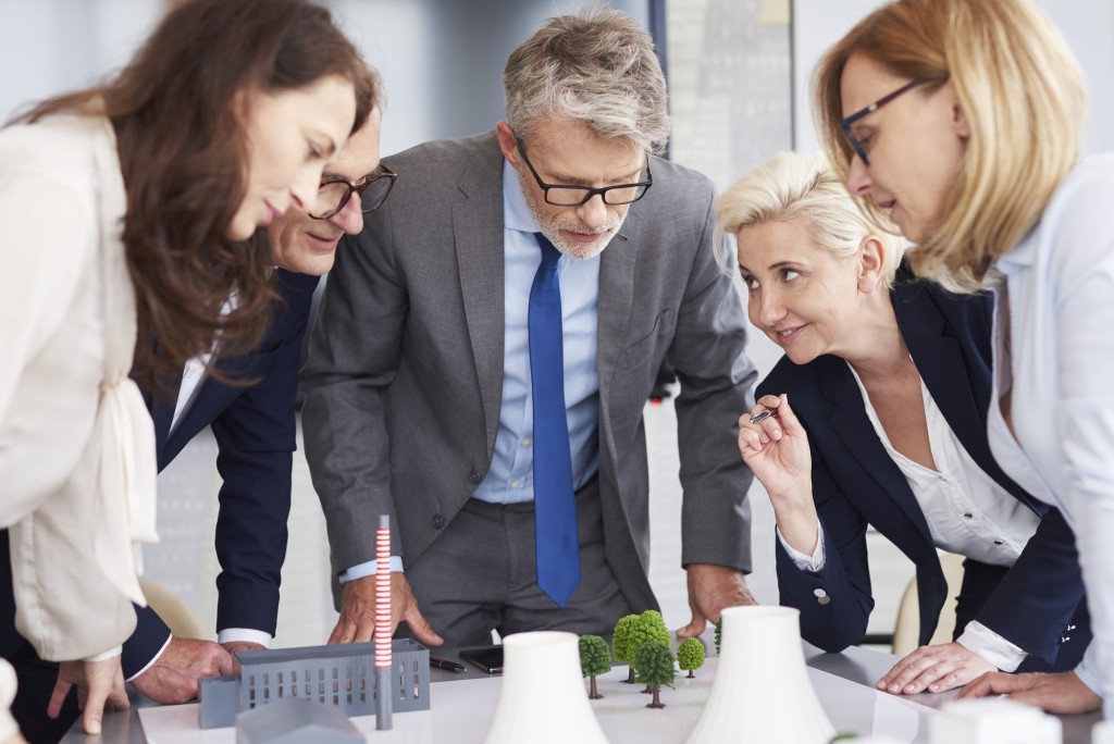 Business leader listening attentively coworkers speech