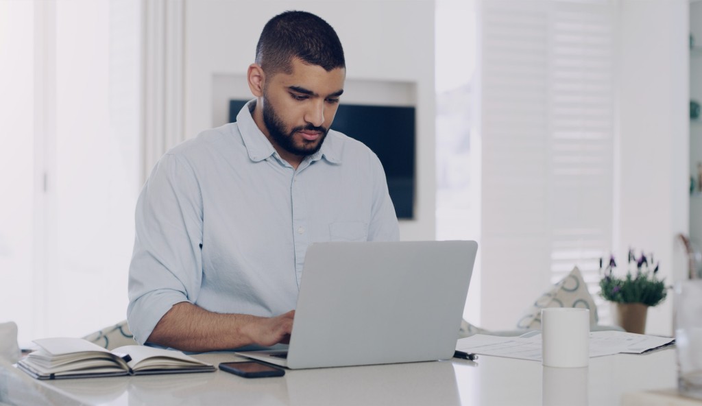 Man, remote work and typing at laptop in home for digital planning, online research and information