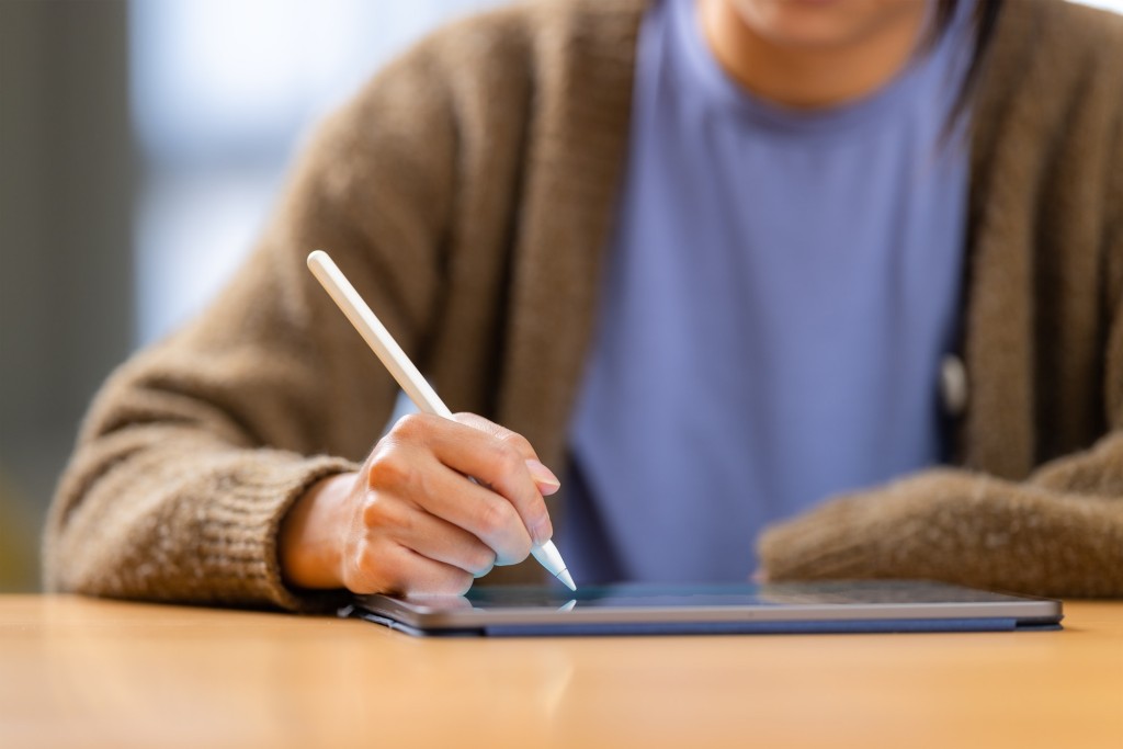 Woman write on the digital tablet computer