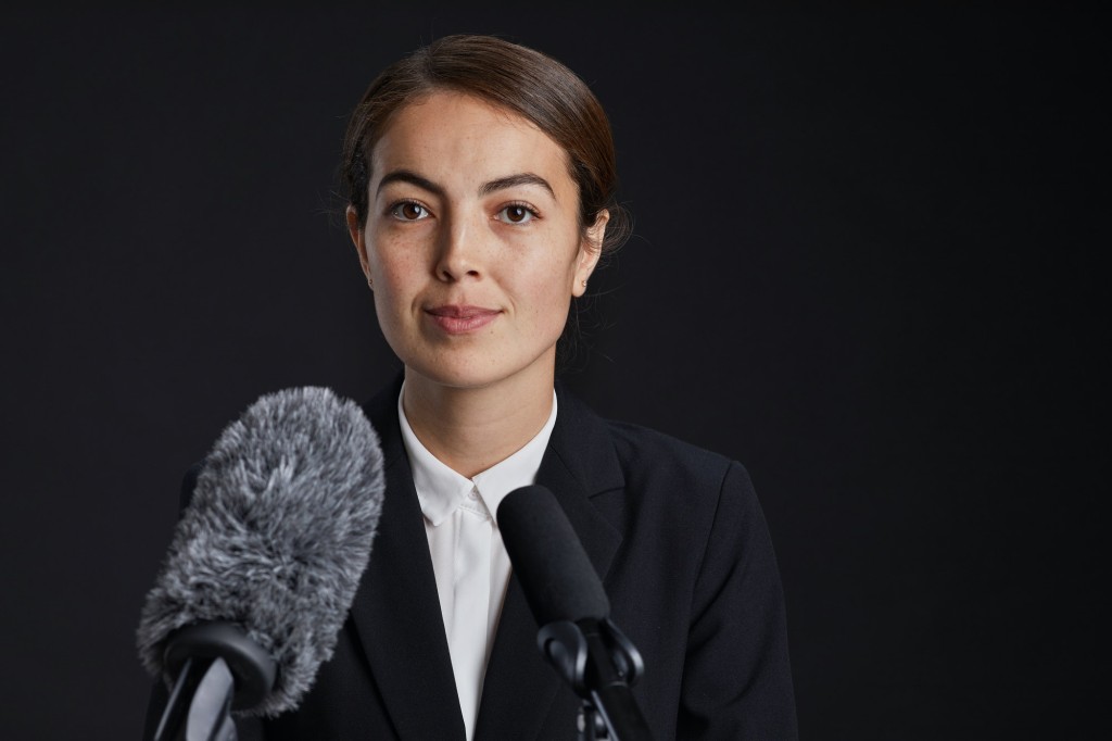 Young Woman Speaking to Microphone